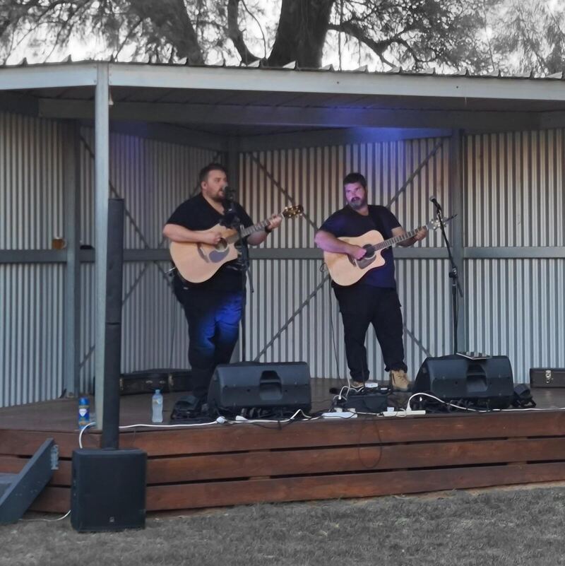 The duo on an outdoor stage