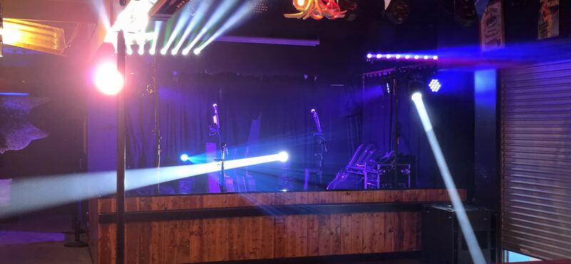 Beam bars and a moving head lighting the stage